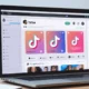Laptop showing a website with an embedded TikTok video feed.