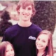 methew gisoni standing outside the house with his stepsisters'