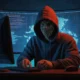 A person sitting at a computer looking confused while viewing a fake website that mimics a real brand. A hacker in a hoodie watches in the background.