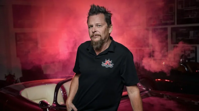 Dave kindig stand beside a car