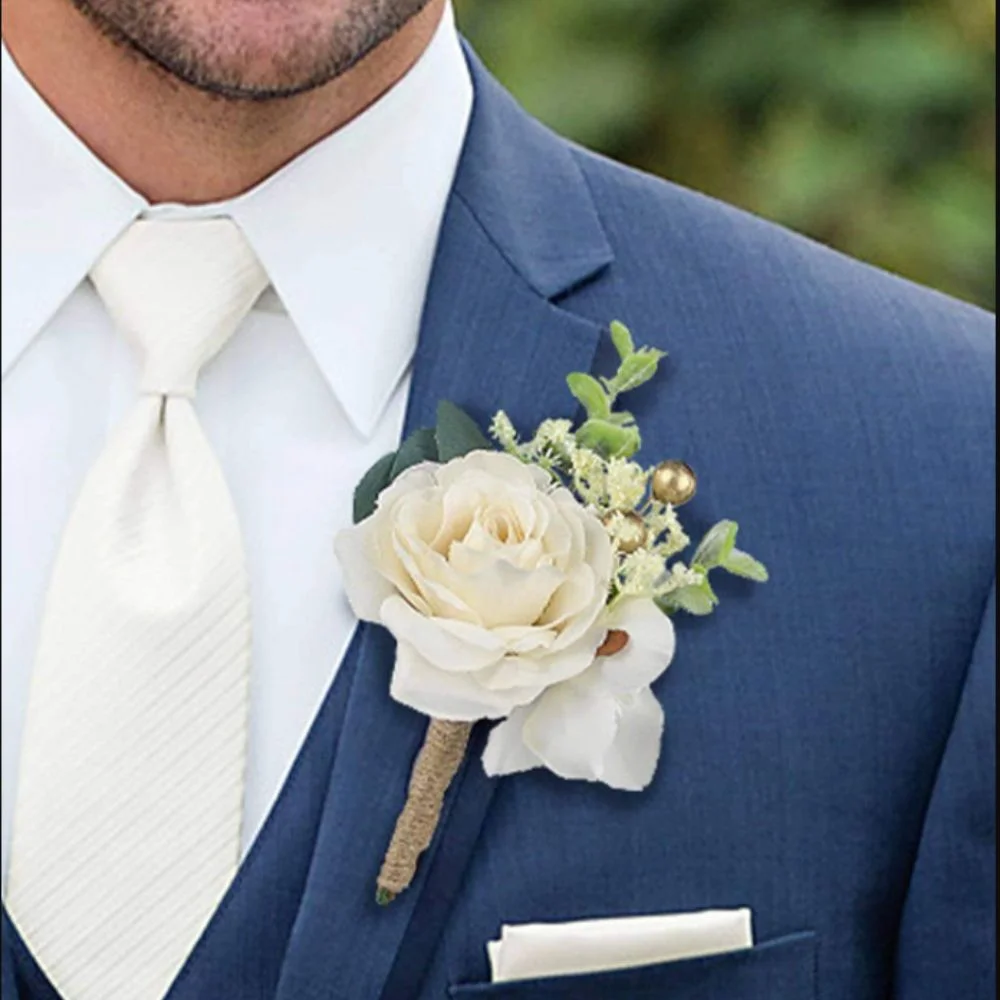 A single white calla lily boutonnière on a tuxedo lapel, wrapped in green floral tape for a clean, modern look