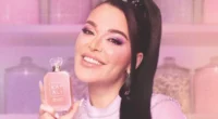 Mona Kattan holding a luxurious Kayali perfume bottle at the brand’s floral-themed launch event.