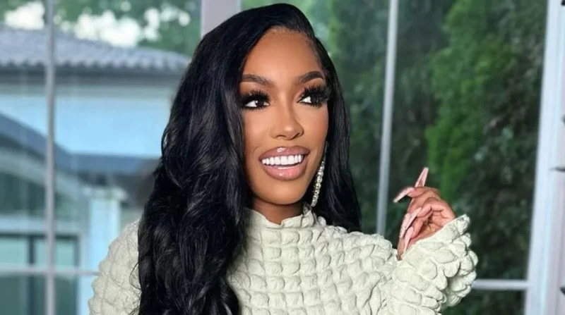 Porsha Williams wearing a stylish white gown, posing confidently.