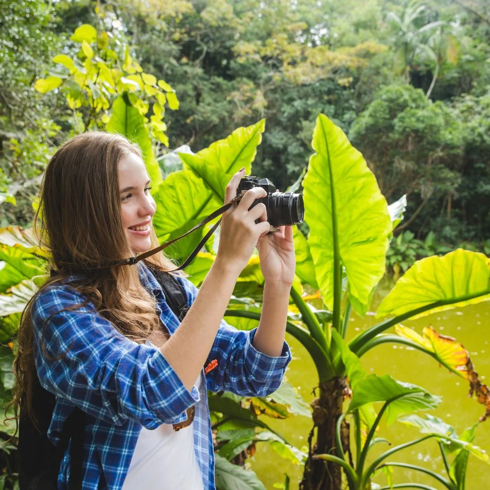 girl taking photo in jugle
