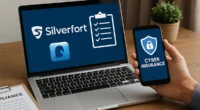 A laptop showing Silverfort security dashboard and a phone displaying cyber insurance verification.